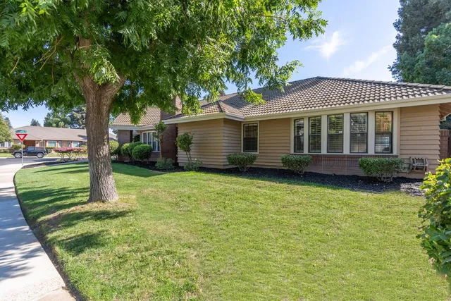 a bathroom with a granite countertop toilet sink and mirror
