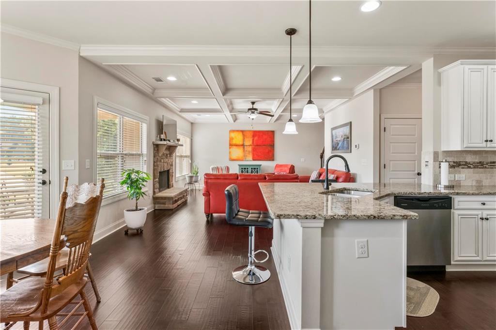 7004 Becca Lane Locust Grove, GA 30248 - Photo 11 of 39 a view of a kitchen with sink microwave and wooden floor