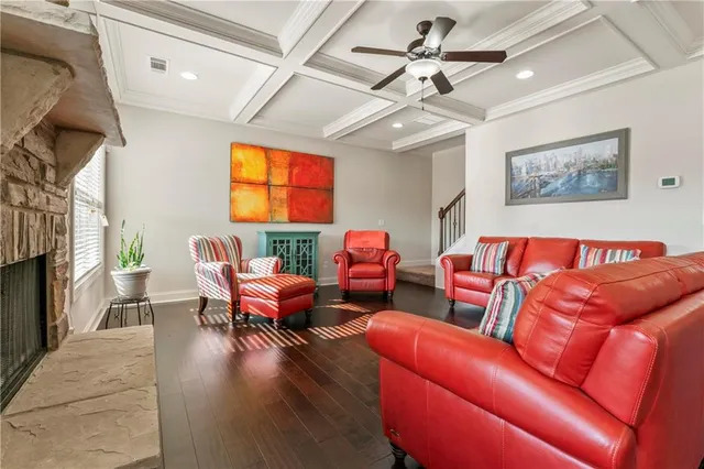 a living room with furniture a fireplace and a chandelier