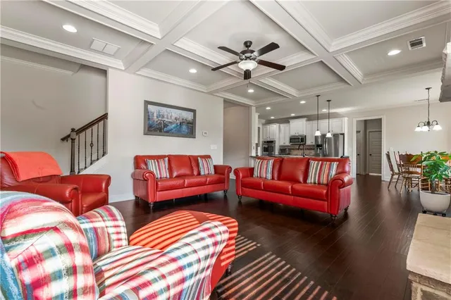a living room with furniture and a chandelier