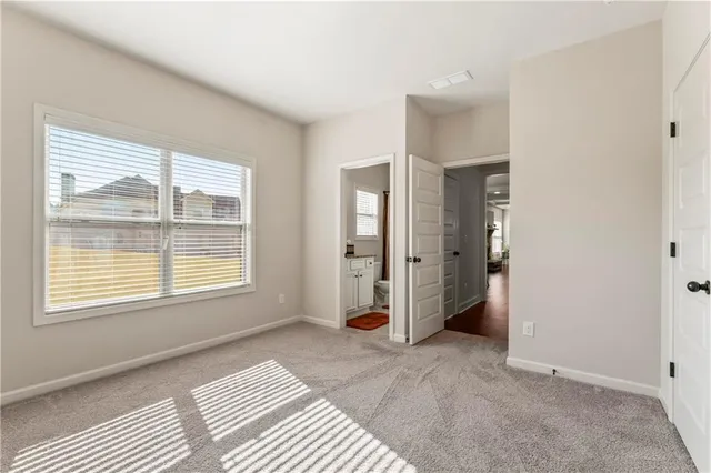 a spacious bedroom with a bed and a window