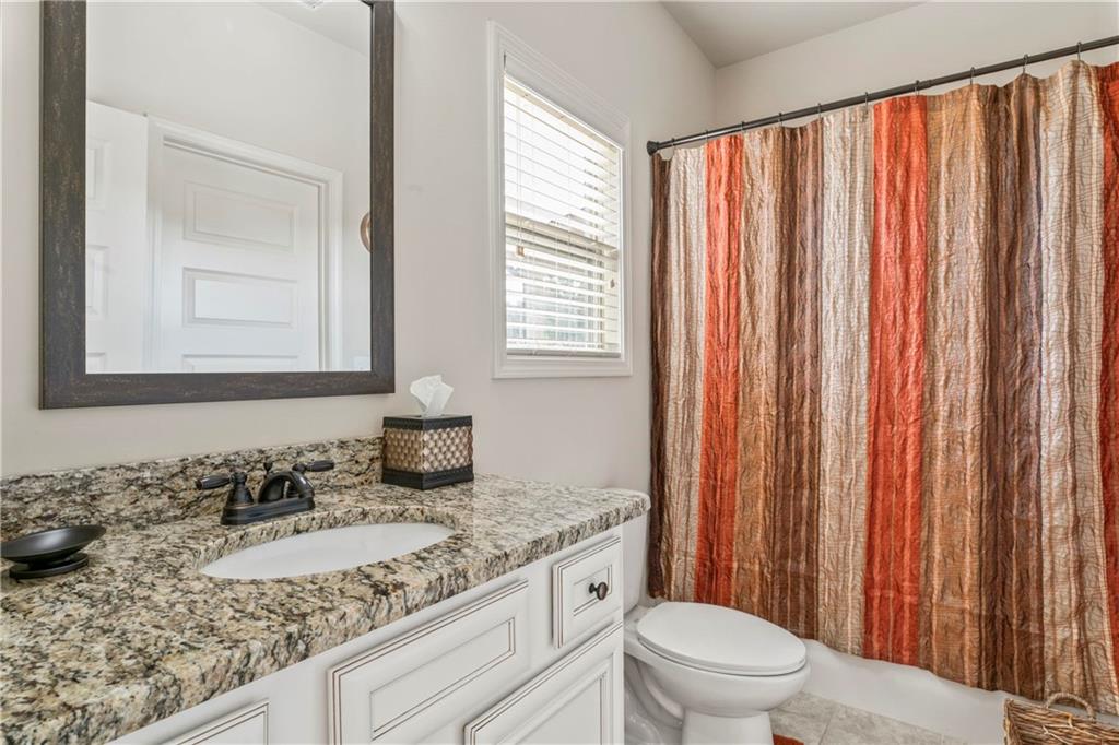 7004 Becca Lane Locust Grove, GA 30248 - Photo 19 of 39 a bathroom with a granite countertop sink and a mirror