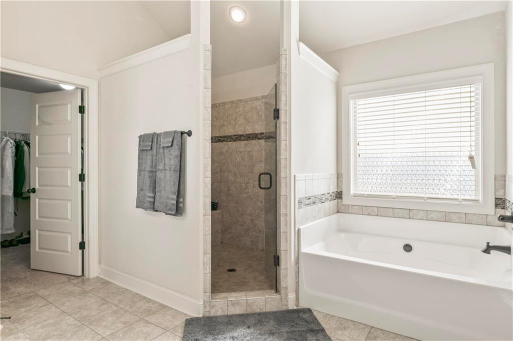 7004 Becca Lane Locust Grove, GA 30248 - Photo 29 of 39 a bathroom with a bathtub shower and a sink
