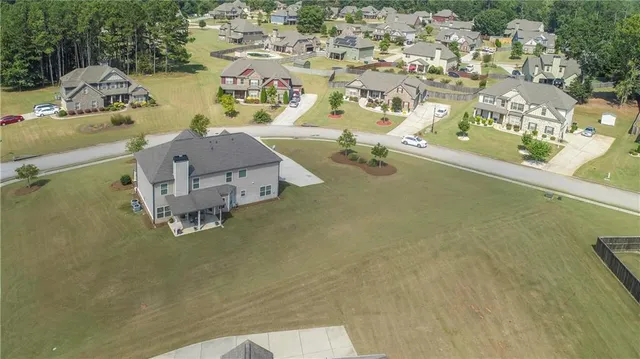 an aerial view of a house with a swimming pool
