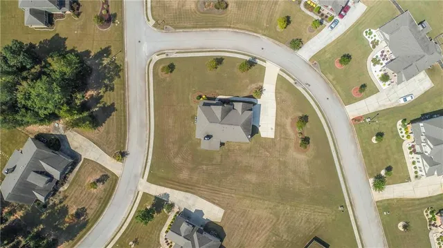 an aerial view of a residential houses with outdoor space