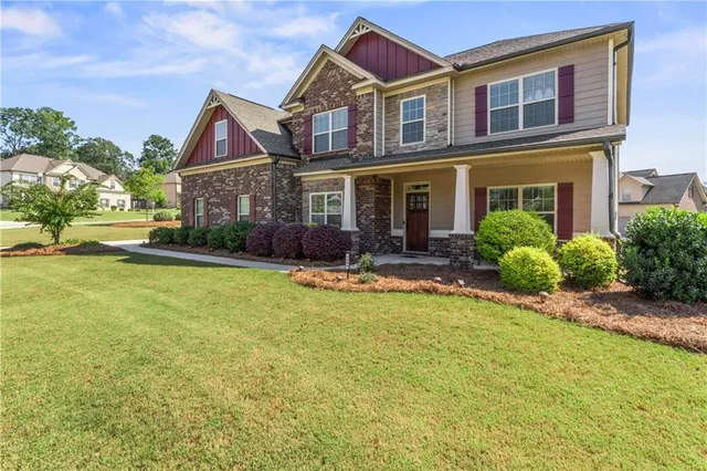 a front view of house with yard and swimming pool