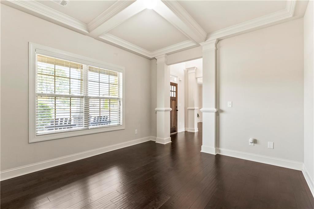 7004 Becca Lane Locust Grove, GA 30248 - Photo 4 of 39 an empty room with wooden floor and windows