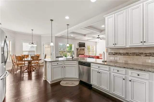 a kitchen with lots of counter top space and painting on the wall