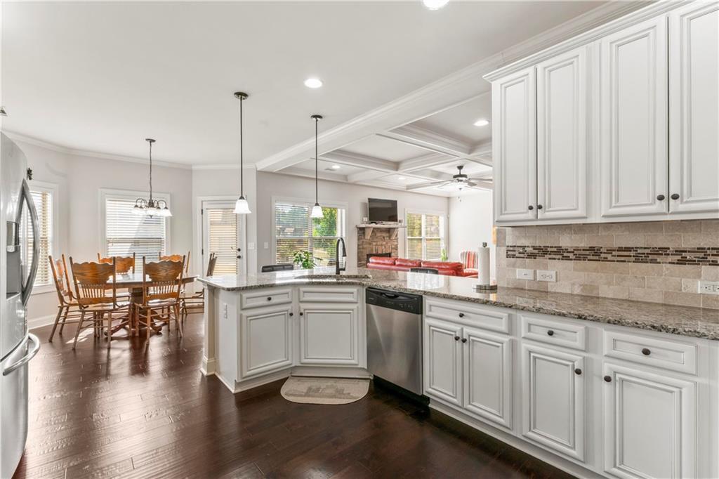 7004 Becca Lane Locust Grove, GA 30248 - Photo 10 of 39 a kitchen with lots of counter top space and painting on the wall
