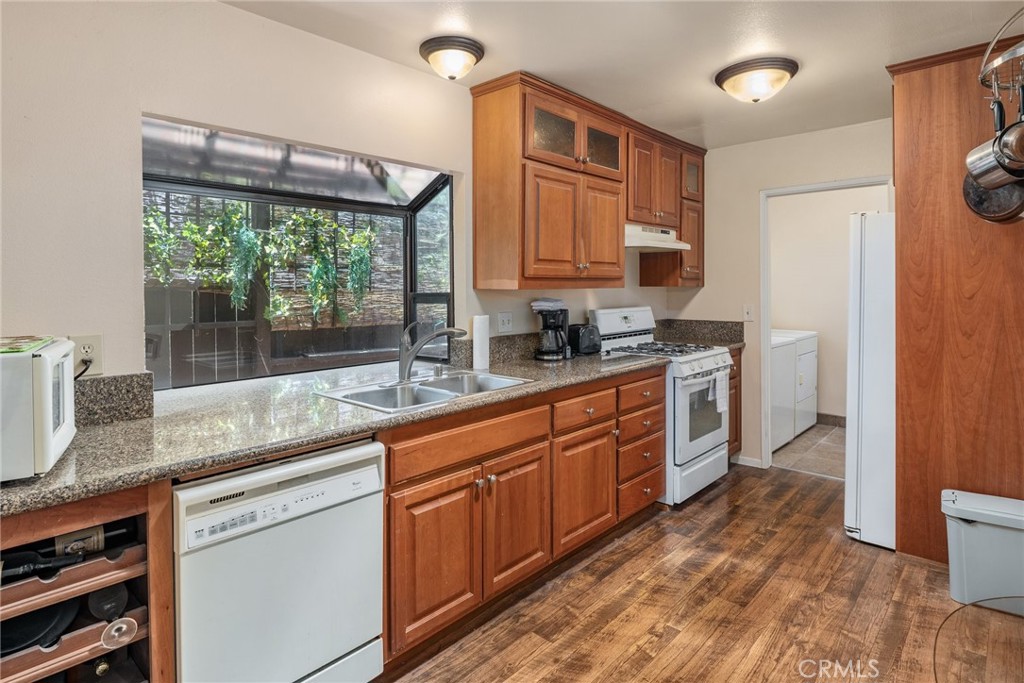 1400 Market Street Vista, CA 92084 - Photo 14 of 31 a kitchen with stainless steel appliances granite countertop a sink a stove and a wooden floors