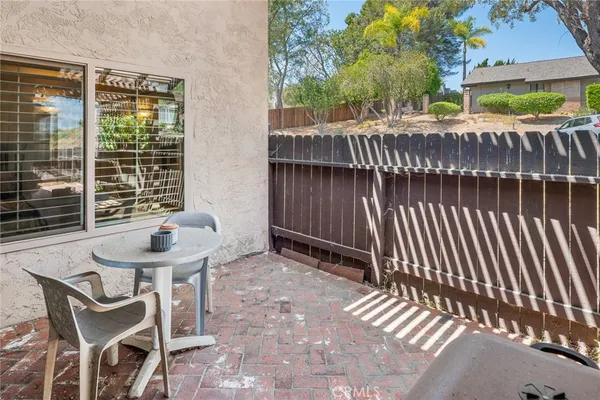 a front view of a house with a yard and potted plants
