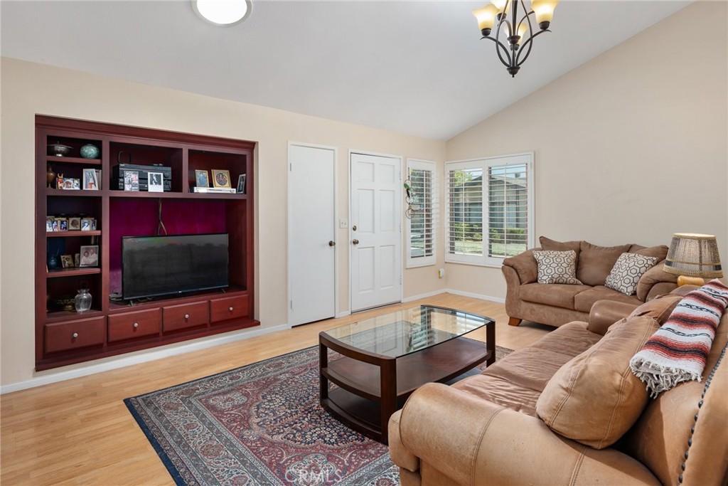 1400 Market Street Vista, CA 92084 - Photo 7 of 31 a living room with furniture a flat screen tv and a floor to ceiling window