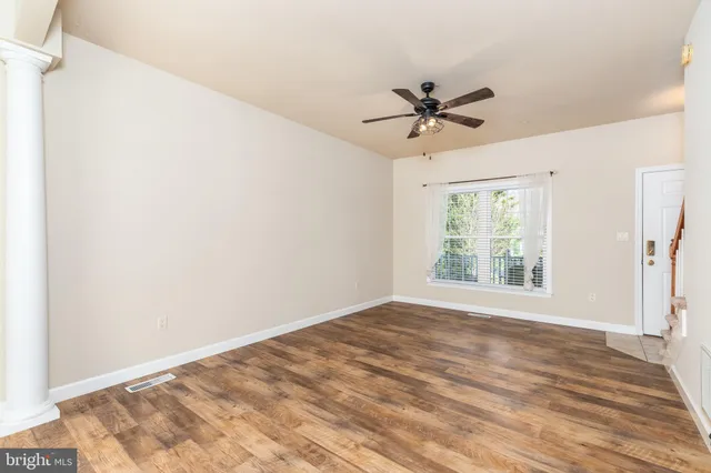 a view of a room with a ceiling fan and a window