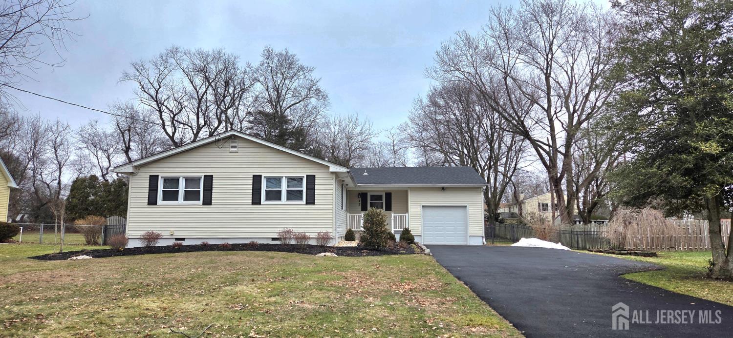 a front view of a house with yard yard and trees