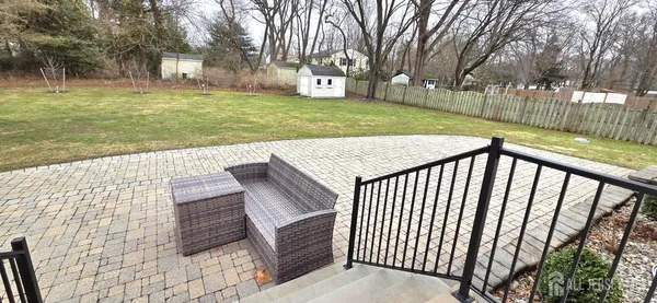 a view of a backyard with wooden fence