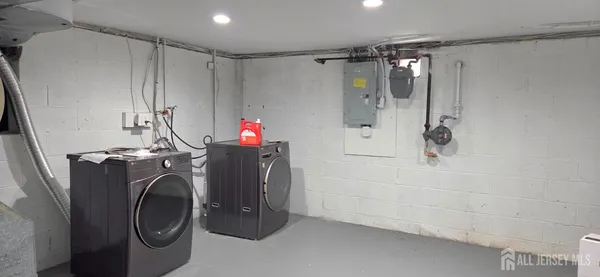 a bathroom with a washing machine and shower
