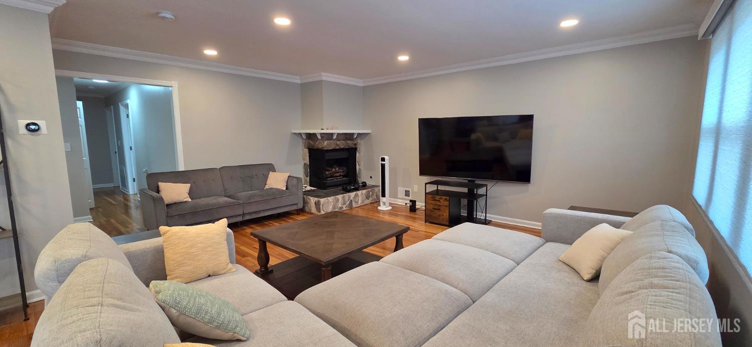 22 Oakbranch Road Cranbury, NJ 08512 - Photo 3 of 20 a living room with furniture and a flat screen tv