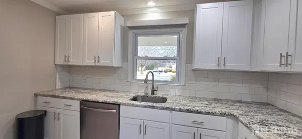 a kitchen with appliances cabinets and a counter top space