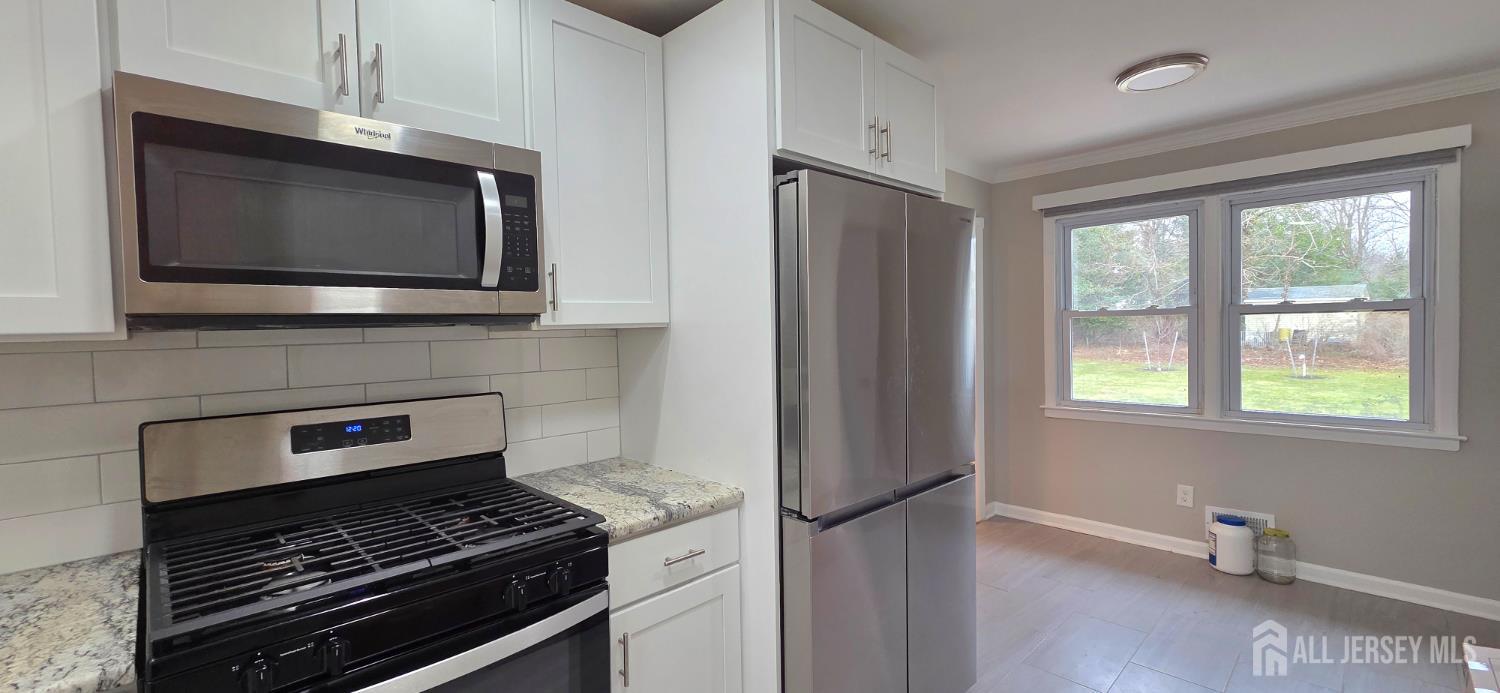 22 Oakbranch Road Cranbury, NJ 08512 - Photo 7 of 20 a kitchen with a stove and a microwave
