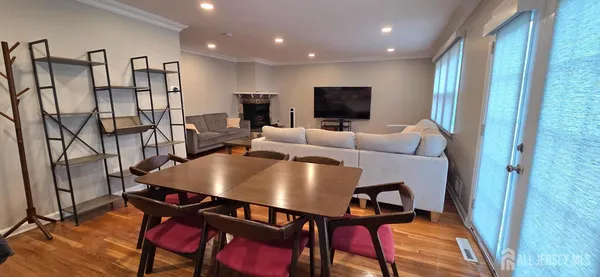 a living room with furniture a flat screen tv and a table