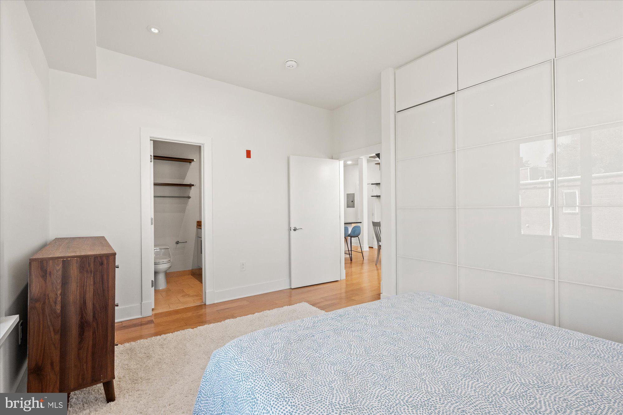 449 R Street Northwest, Unit 301 Washington, DC 20001 - Photo 16 of 37 a bedroom with a bed and a dresser
