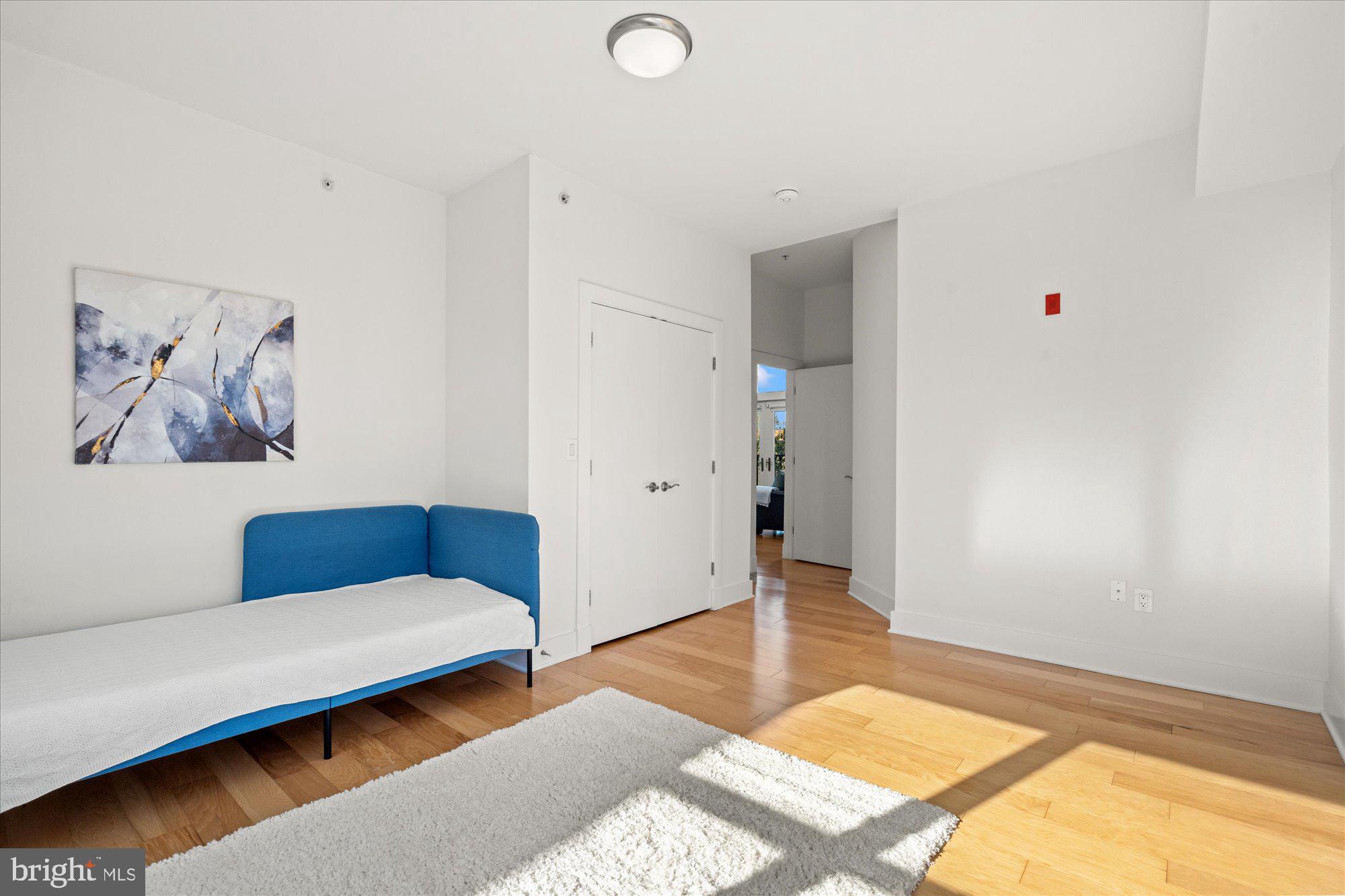 449 R Street Northwest, Unit 301 Washington, DC 20001 - Photo 17 of 37 a bedroom with a bed and a couch