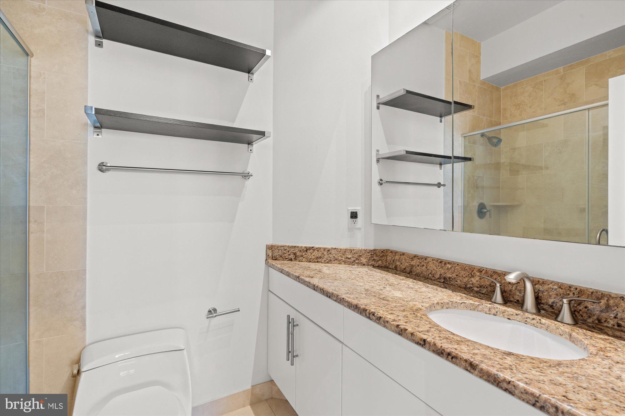 449 R Street Northwest, Unit 301 Washington, DC 20001 - Photo 19 of 37 a bathroom with a granite countertop sink and a mirror