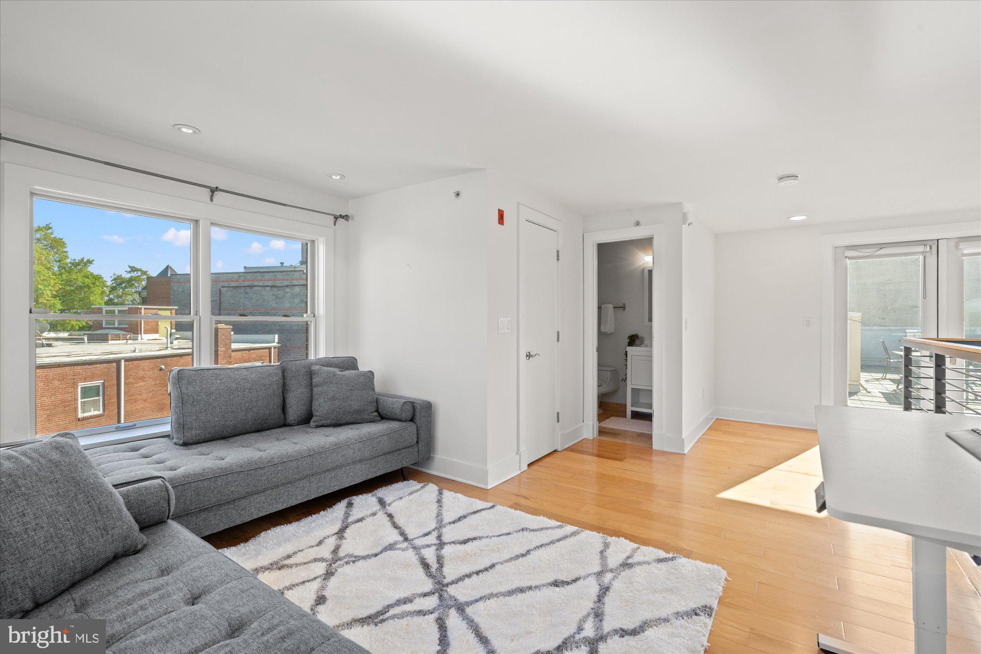 449 R Street Northwest, Unit 301 Washington, DC 20001 - Photo 22 of 37 a living room with furniture and a large window