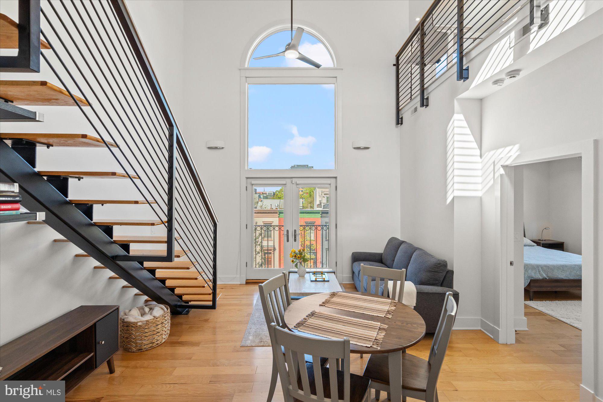 449 R Street Northwest, Unit 301 Washington, DC 20001 - Photo 26 of 37 a view of a livingroom with furniture staircase and kitchen view