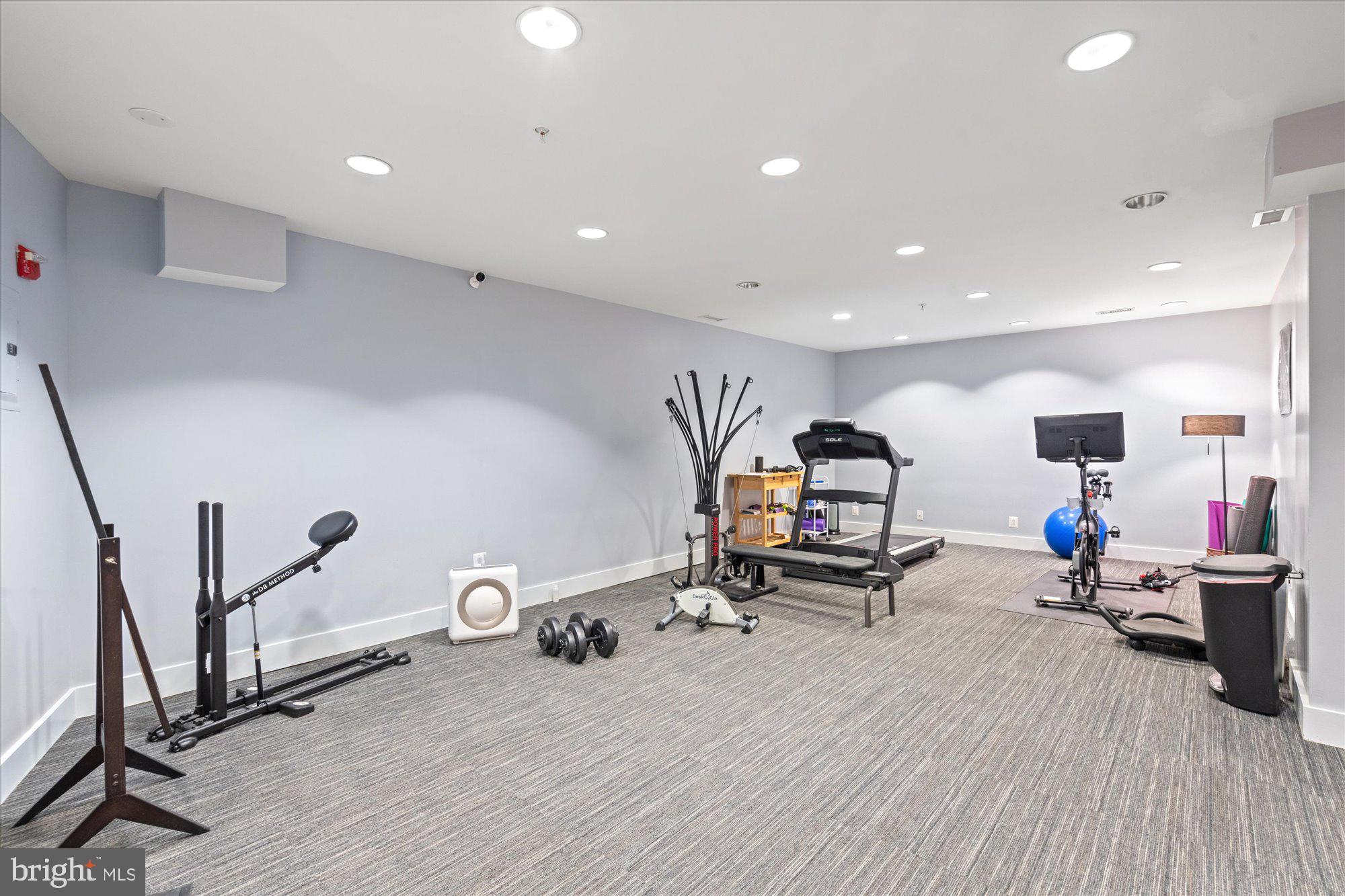449 R Street Northwest, Unit 301 Washington, DC 20001 - Photo 31 of 37 a room with gym equipment and a wooden floor