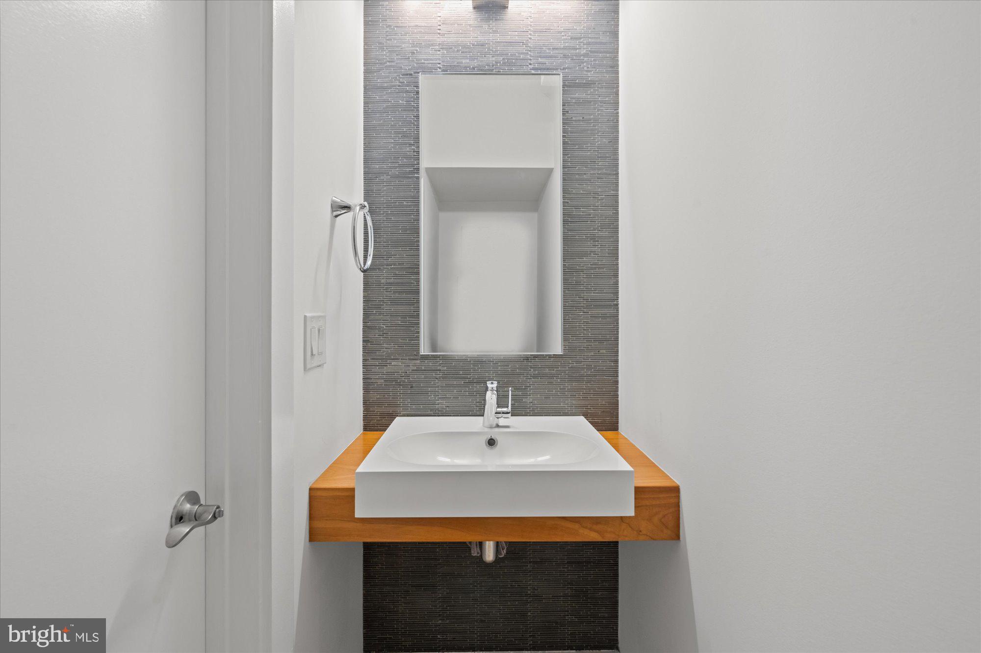 449 R Street Northwest, Unit 301 Washington, DC 20001 - Photo 6 of 37 a bathroom with a sink and a mirror