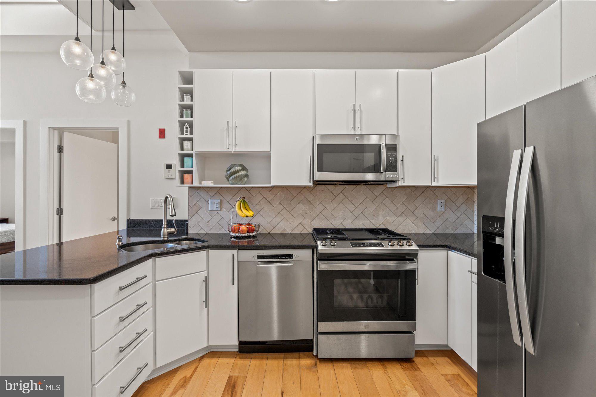 449 R Street Northwest, Unit 301 Washington, DC 20001 - Photo 8 of 37 a kitchen with stainless steel appliances granite countertop a stove a sink and a refrigerator