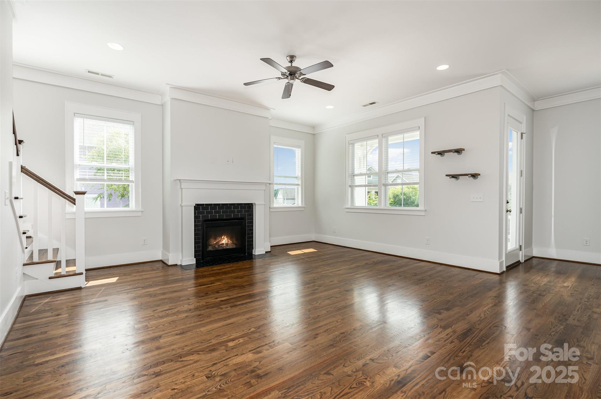 526 Spring Landing Drive Rock Hill, SC 29730 - Photo 15 of 48 an empty room with wooden floor fireplace and windows