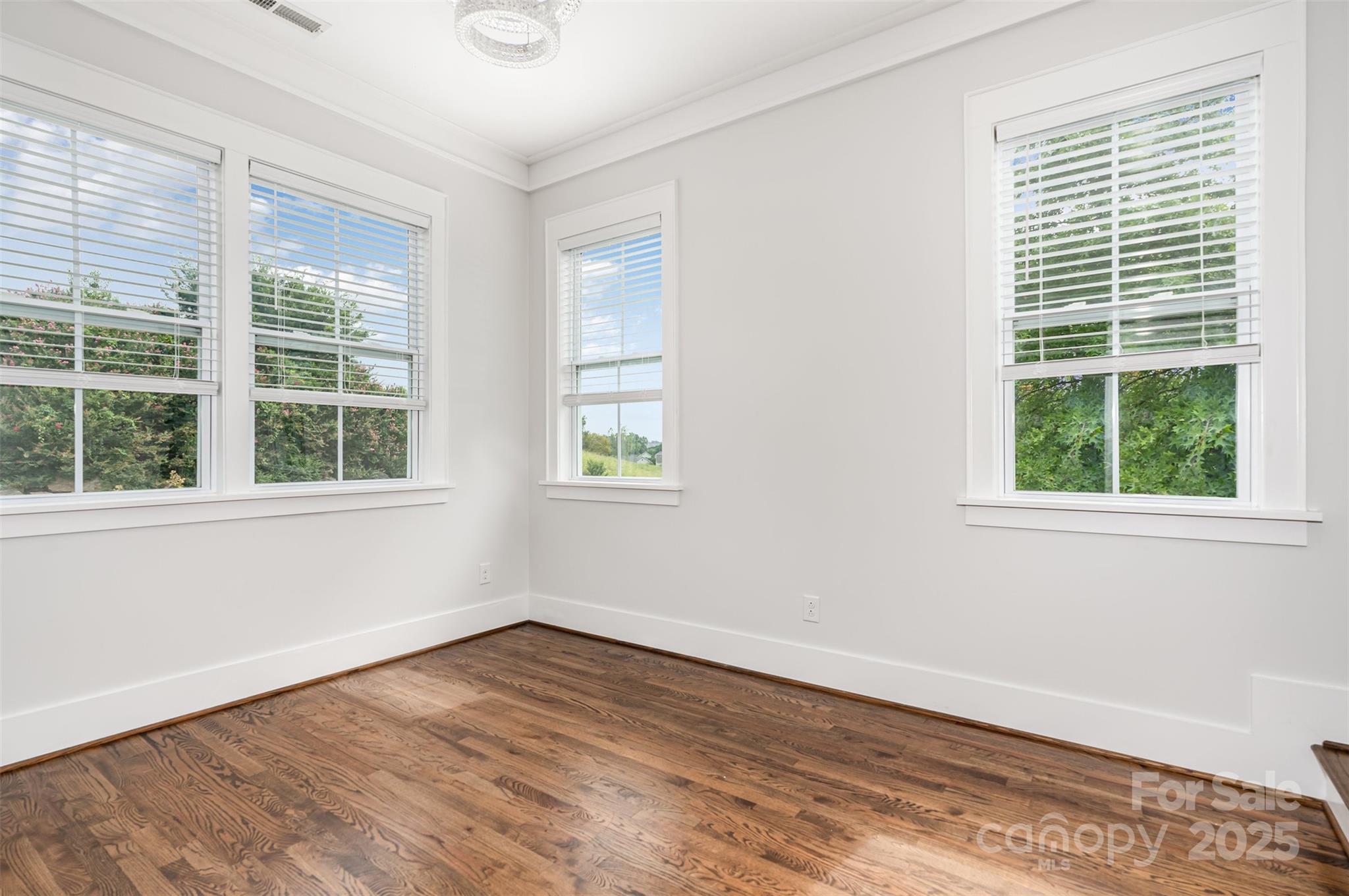526 Spring Landing Drive Rock Hill, SC 29730 - Photo 17 of 48 a view of an empty room with wooden floor and windows