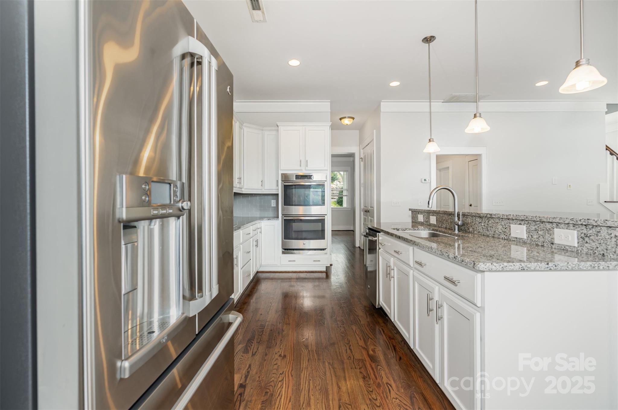 526 Spring Landing Drive Rock Hill, SC 29730 - Photo 23 of 48 a kitchen with stainless steel appliances granite countertop a refrigerator a oven and a sink with wooden floor