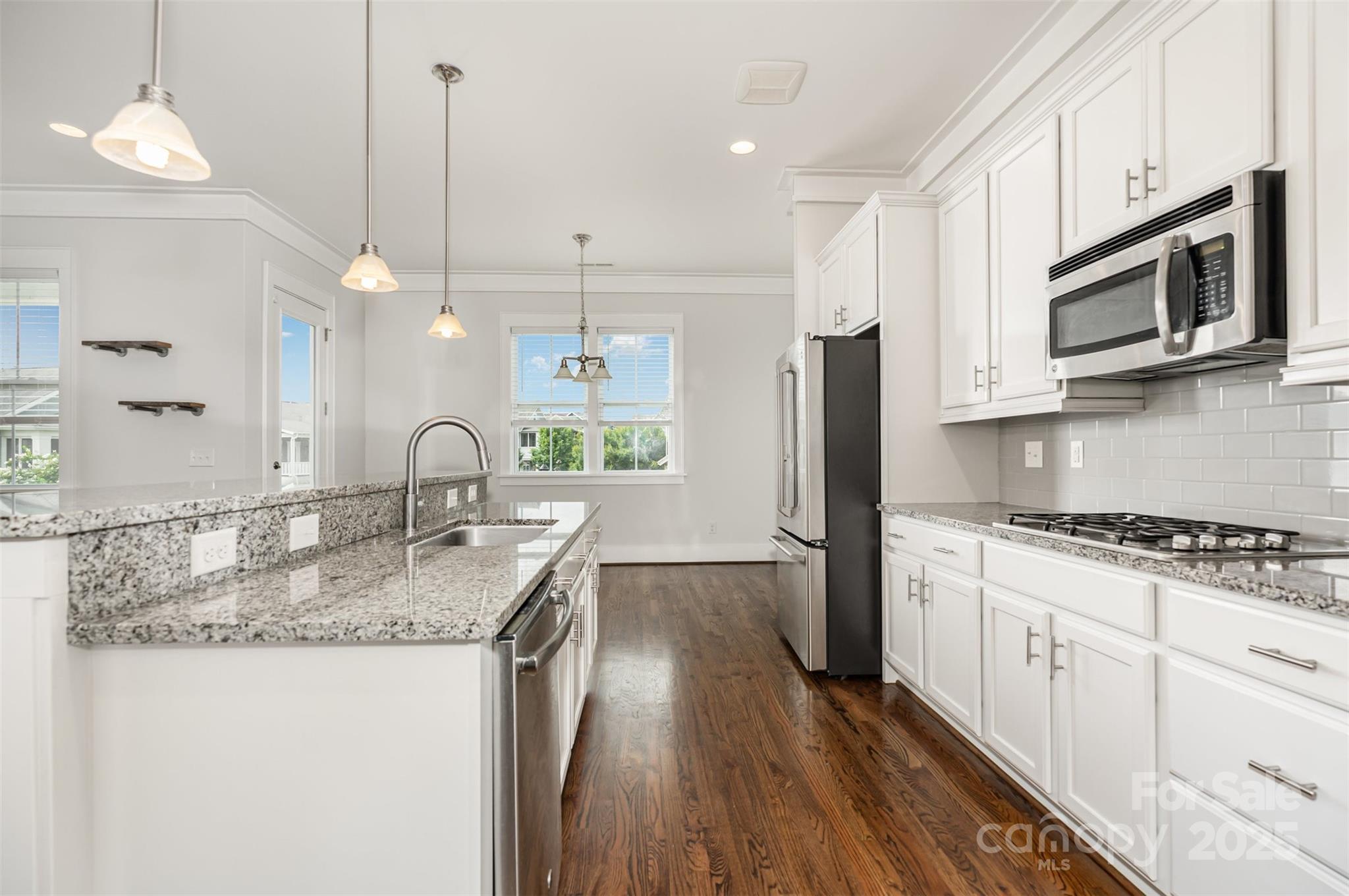 526 Spring Landing Drive Rock Hill, SC 29730 - Photo 24 of 48 a kitchen with stainless steel appliances granite countertop a sink a stove and a wooden floors