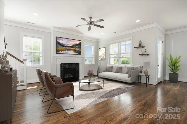 a view of an empty room with wooden floor and windows