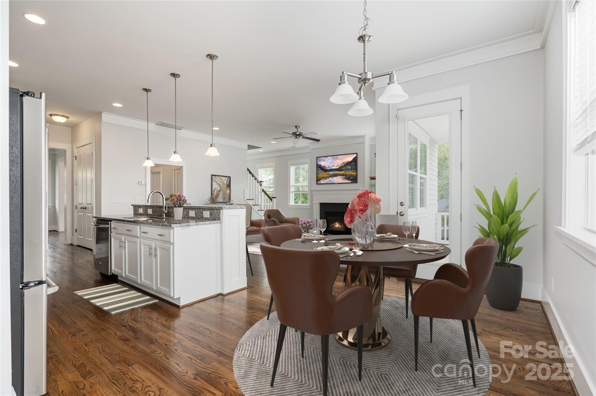 526 Spring Landing Drive Rock Hill, SC 29730 - Photo 8 of 48 a dining room with furniture a chandelier and wooden floor
