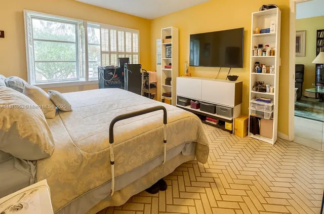 a spacious bedroom with a bed and large windows