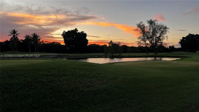 a view of outdoor space with green field and trees