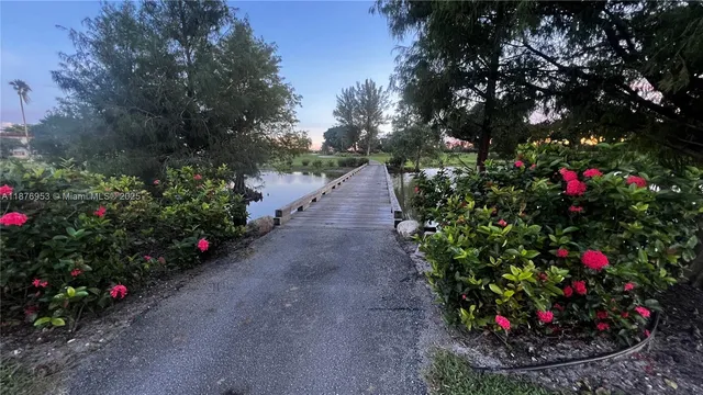 a view of a pathway in a yard with wooden fence