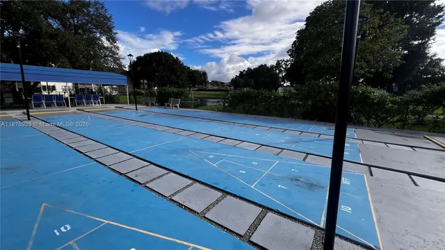 a patio with an outdoor dining table and chairs under an umbrella