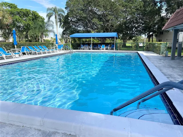 a green field with lots of trees