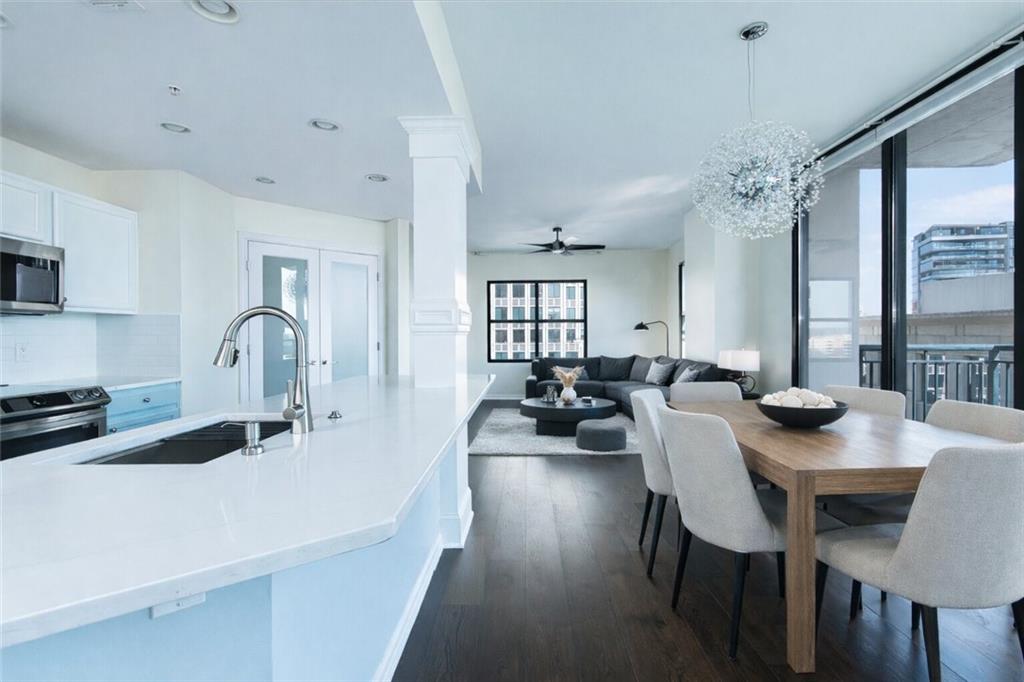 3040 Peachtree Road, Unit 1003 Atlanta, GA 30305 - Photo 1 of 42 a kitchen with sink dining table and chairs