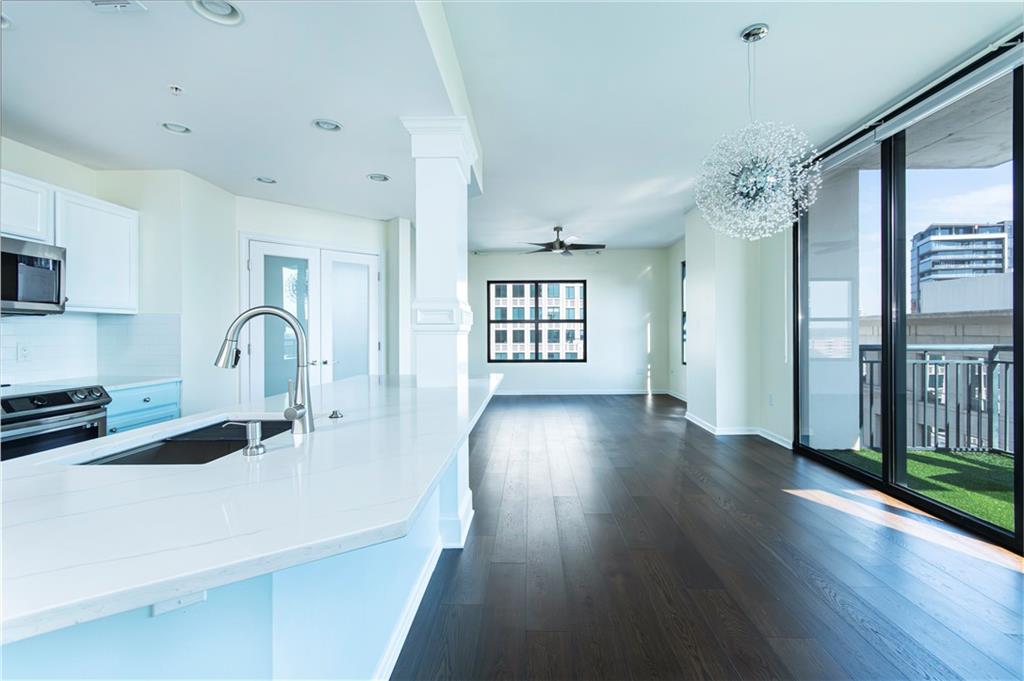 3040 Peachtree Road, Unit 1003 Atlanta, GA 30305 - Photo 13 of 42 a view of a kitchen with a sink a refrigerator and wooden floor