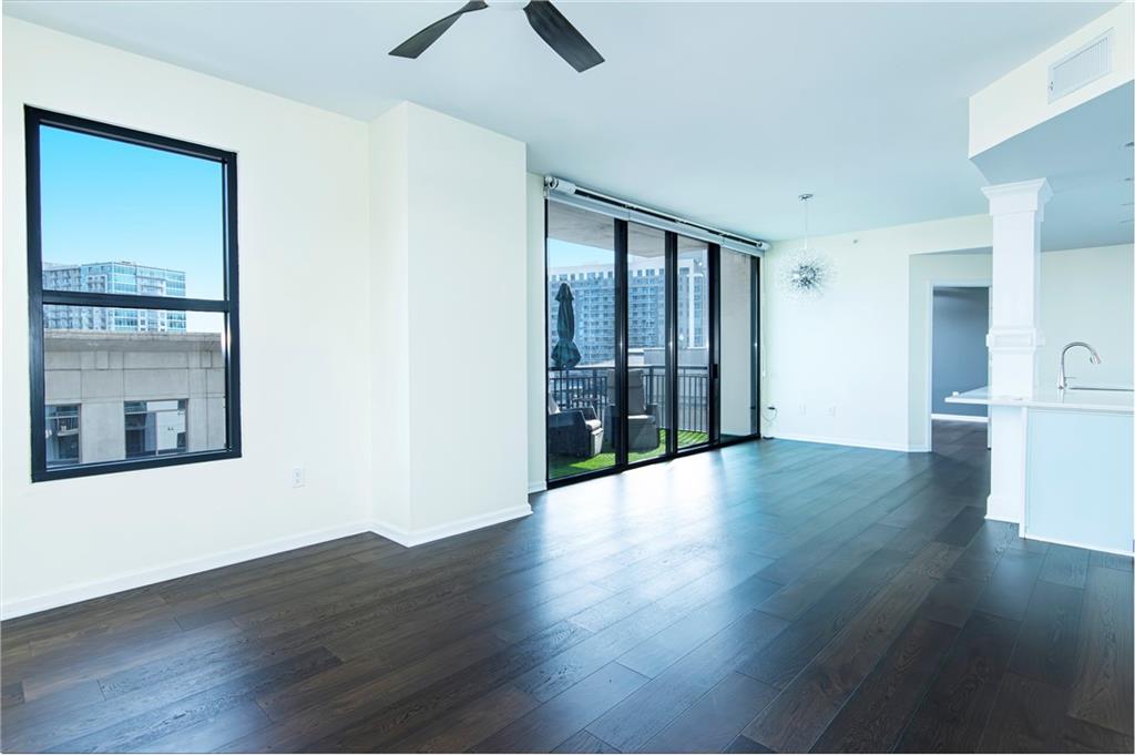 3040 Peachtree Road, Unit 1003 Atlanta, GA 30305 - Photo 14 of 42 a view of an empty room with wooden floor and a window