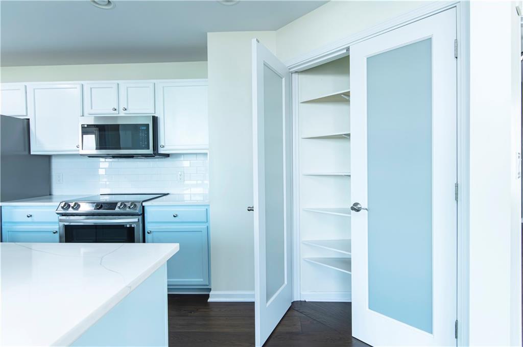 3040 Peachtree Road, Unit 1003 Atlanta, GA 30305 - Photo 15 of 42 a kitchen with stainless steel appliances a stove and a refrigerator