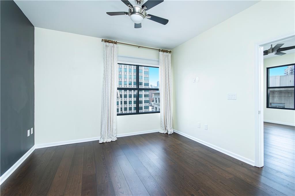 3040 Peachtree Road, Unit 1003 Atlanta, GA 30305 - Photo 16 of 42 wooden floor in an empty room with a window