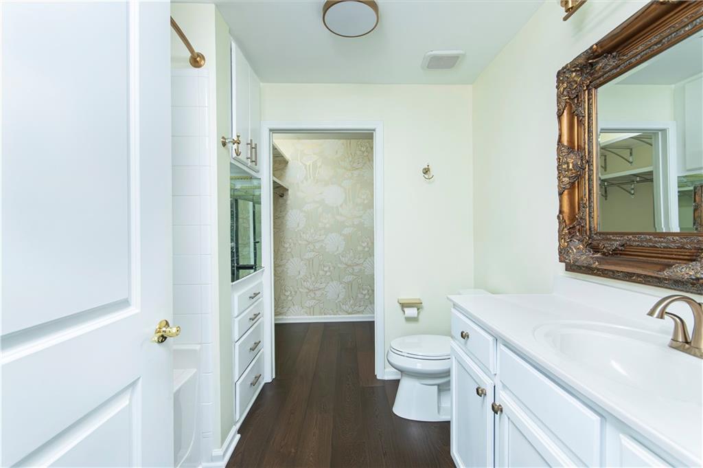 3040 Peachtree Road, Unit 1003 Atlanta, GA 30305 - Photo 17 of 42 a bathroom with a granite countertop sink toilet and shower