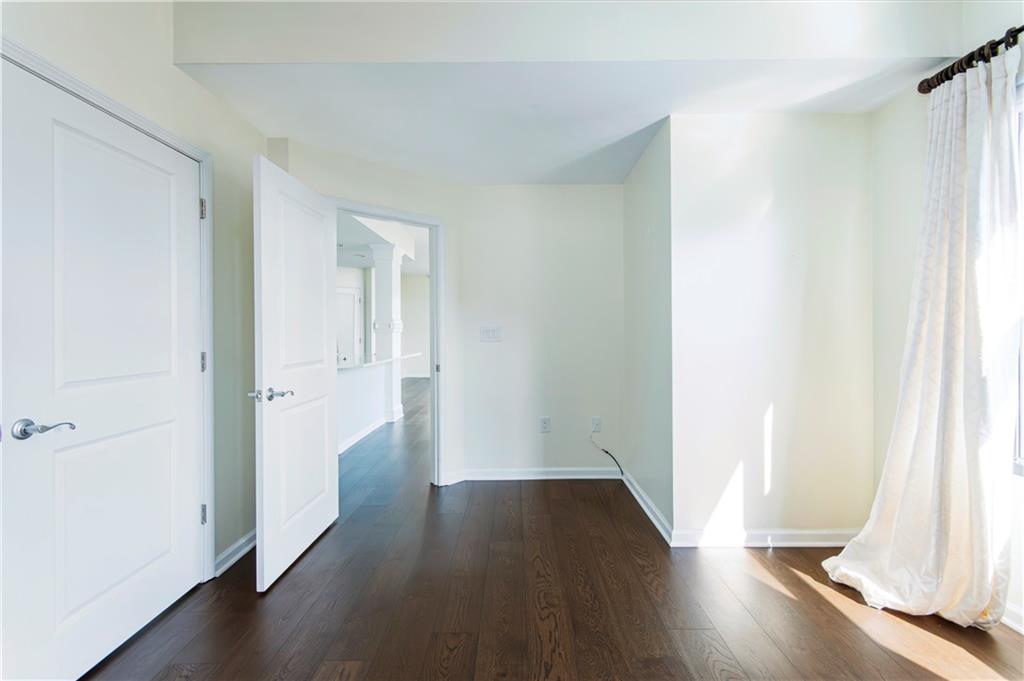 3040 Peachtree Road, Unit 1003 Atlanta, GA 30305 - Photo 19 of 42 an empty room with wooden floor and a window